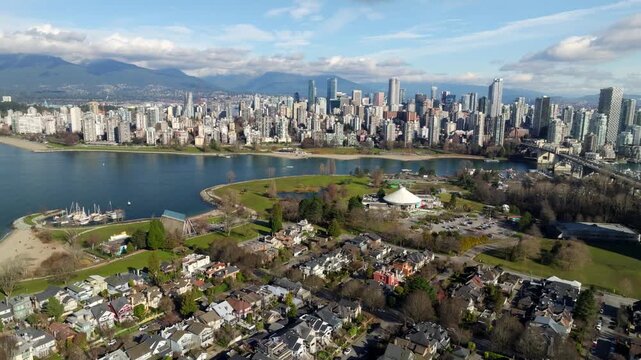 Vancouver Skyline From Vanier Park Along The Waterfront Near Kitsilano Neighbourhood In British Columbia, Canada. Aerial Pullback Shot