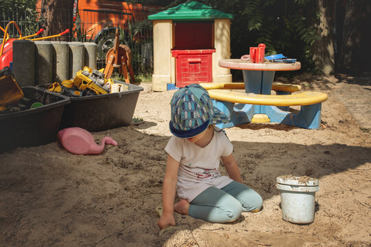 Ein spielendes Kind im Sandkasten.