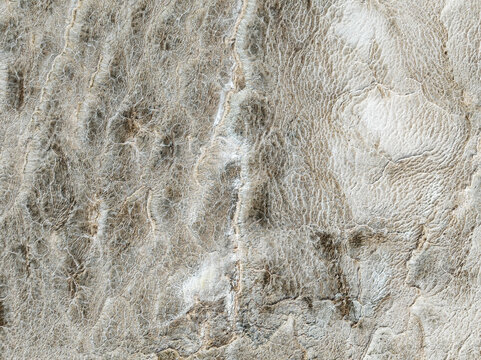 Aerial view of the parched earth reveals a tapestry of bleached textures, etched by time and weather, creating an abstract, otherworldly landscape, Walvis Bay, Erongo Region, Namibia.