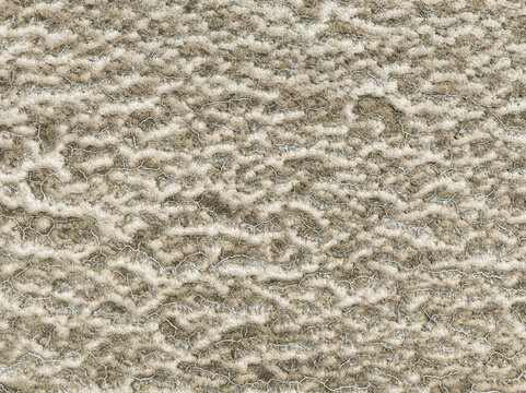 Aerial view of an intricate tapestry of white salt patterns etched across the arid landscape, creating a stark contrast with the underlying earth, Walvis Bay, Erongo Region, Namibia.
