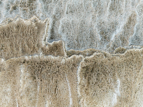 Aerial view of intricate earth patterns etched into the landscape, revealing a tapestry of textures and tones, Walvis Bay, Erongo Region, Namibia.