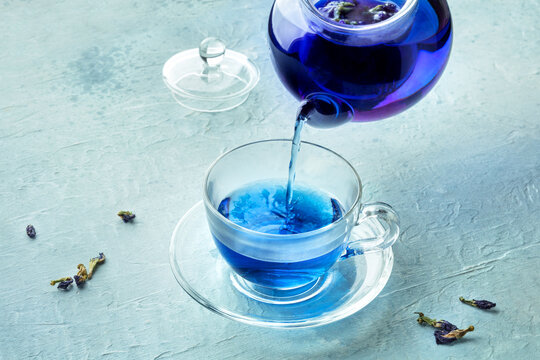 Blue tea, an infusion of butterfly pea flowers, being poured into a cup