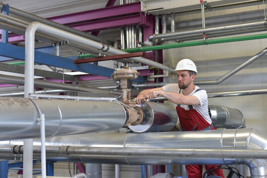 Mechanics repair a machine in a modern industrial plant - professionell occupation job