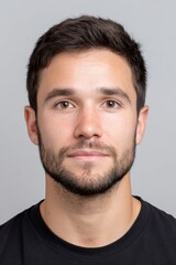 Photo ID portrait of a young Argentinian man with a neutral expression