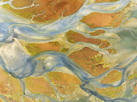 Aerial view of the vivid contrast between the winding waterways and the golden earth creates a stunning natural tapestry, Walvis Bay, Erongo Region, Namibia.