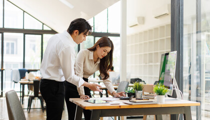 Obraz premium Asian Professionals Reviewing Business Colleagues Discussing ESG and Sustainability Strategy in Modern Office 