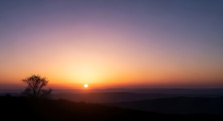 Fototapeta premium Vibrant sunrise paints the tranquil horizon with breathtaking hues of orange and purple, casting long shadows over the serene landscape below