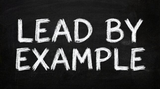 Lead by Example Chalkboard Message with Black Background, and Education Concept.