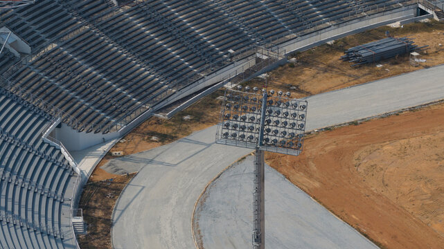 Aerial view of the stadium with rows of seats and a dirt track, bathed in the soft glow of the sun, Muang Pattaya, Thailand.
