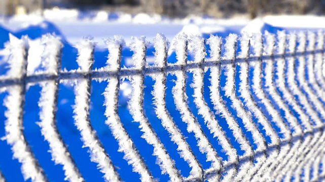 Ice crystals and hoarfrost covering a wire fence