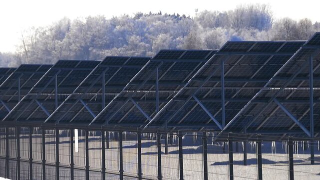 Solar panels melting snow and ice on a sunny winter day