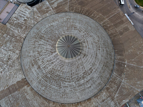 Aerial view of the stark concrete dome, its circular geometry contrasting with the linear road and sparse greenery below, Thessaloniki, Thessaloniki, Greece.