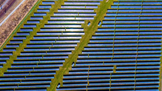 Aerial view of gleaming solar panels stretch across the landscape, reflecting the sky, a testament to renewable energy, Sevetin, South Bohemian Region, Czechia.