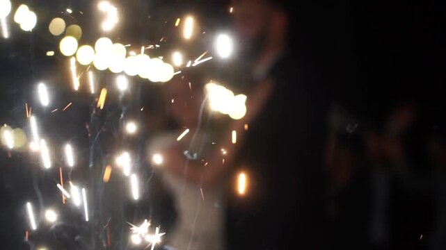 happy bride and groom are standing in the hallway of the fountains of the fireworks. beautiful end to the wedding day celebration
