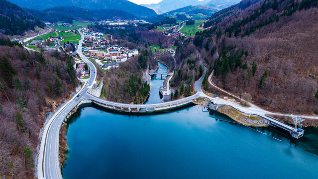 Aerial view of the dam and surrounding landscape where the tranquil blue reservoir contrasts with the verdant hills and the village, Klaus an der Pyhrnbahn, Oberosterreich, Austria.