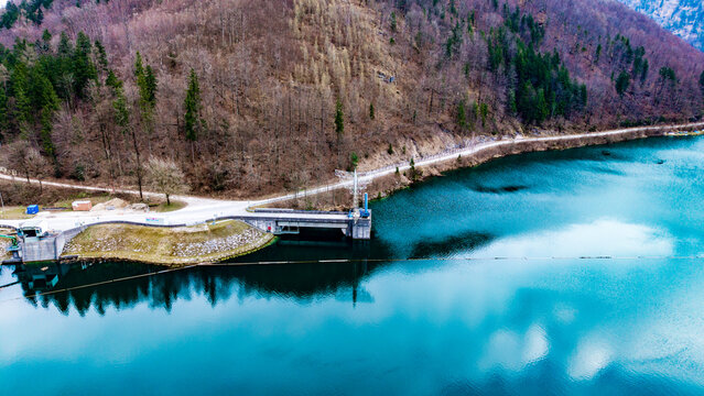 Aerial view of the Klaus Dam reflecting the sky, nestled amidst verdant forests and rugged mountains, a serene landscape of blue and green contrasts, Klaus an der Pyhrnbahn, Oberosterreich, Austria.