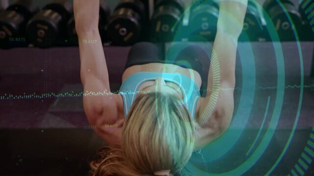 Wearable sending pulse, midadult woman lifting and bringing arms in slow arcs for mobility tracking