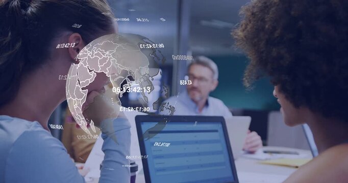 Team reviewing laptop, papers, laptop input causing 3D globe moving over team for business review