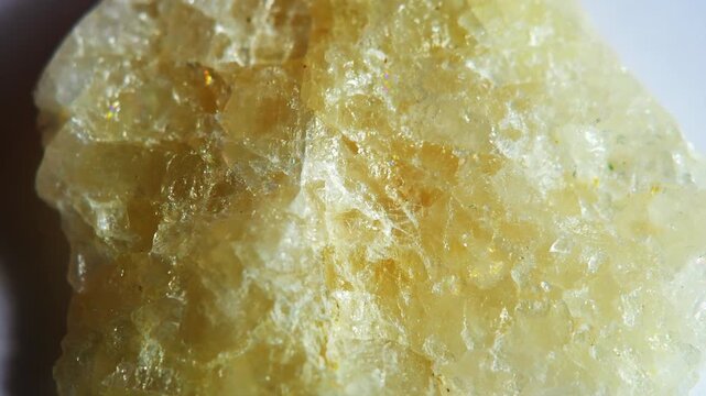 The surface of a sea quartz crystal at high magnification. A mica stone in soft focus.