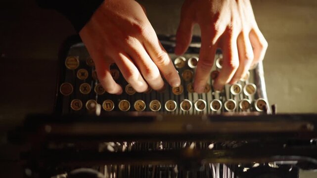 Close up shot of man typing on old vintage retro typewriter; backlit; news, media or communication concept. Cinematic shot of hands typing under beautiful sun light. Old fashioned typing machine