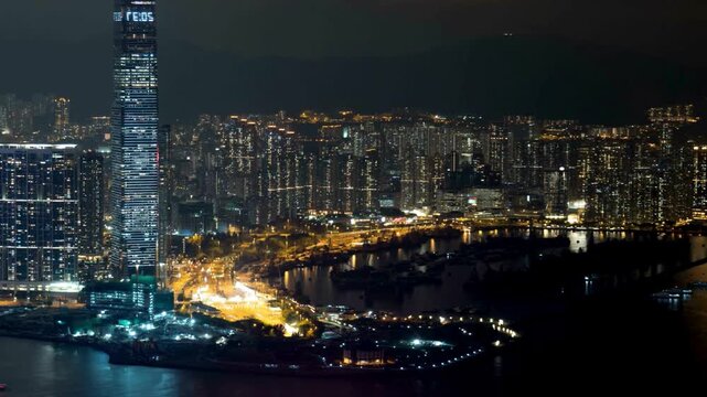 Stunning Aerial night view of the ICC skyscraper and West Kowloon skyline in Hong Kong. Tourism point and tourism industry 
