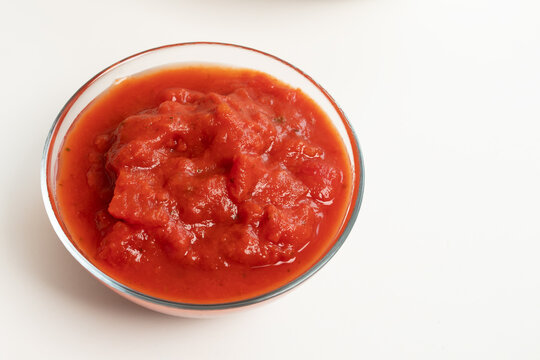 tomato sauce in a glass bowl on a white background, created as a clean cooking ingredient visual for recipe layouts, food packaging, kabsa preparation