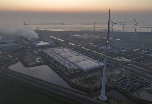 Aerial view of a large hyperscale data center in eemshaven, netherlands, leveraging renewable wind turbine power