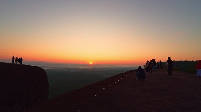 Bueng Kan, Thailand. 02 December 2025; Three Whale Rock Iconic Viewpoint of Northeastern Thailand. Epic sunrise at a famous Thai viewpoint, capturing tiny human figures on a colossal rock ledge