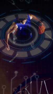 Vertical video: Male athlete dribbling toward rim and dunking, HUD tracking hoop for sports tech
