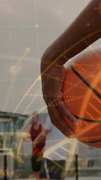 Vertical video: Right hand holding ball duo coming preparing pass DNA helix over hand, sports court