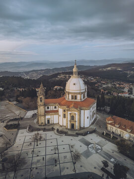 Aerial view of the imposing Santuario de Nossa Senhora do Sameiro, its white facade contrasting with the red roof, nestled amidst a landscape of rolling hills, Braga, Braga, Portugal.