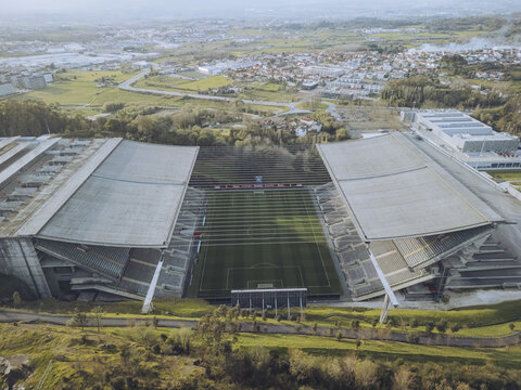 Aerial view of the imposing Braga Municipal Stadium, a concrete marvel nestled amidst verdant hills and urban sprawl, Braga, Braga, Portugal.