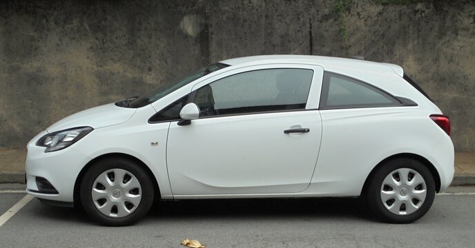 White Opel Corsa hatchback car parked in street