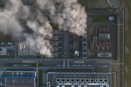 Aerial view of industrial park cooling towers emitting steam from above
