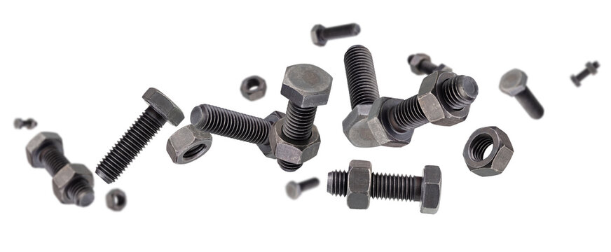 Black hardened bolts and nuts fly and levitate in space. Isolated on white.
