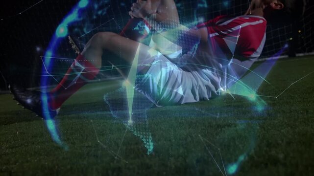 Animation of data processing over injured caucasian football player on football pitch