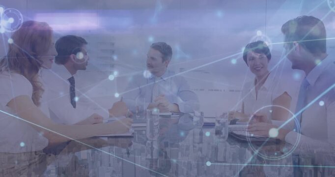 Animation of connected dots and aerial view of cityscape over diverse coworkers sharing ideas