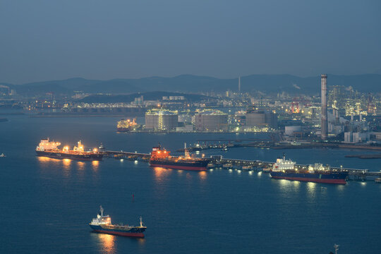 Oil tankers unloading at an oil refinery in Ulsan. Aerial view of port oil infrastructure, storage terminal pier and refinery plants.