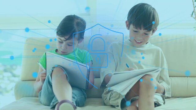 Animation of spots and padlock over caucasian schoolchildren learning on couch
