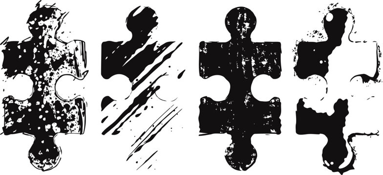 black grunge puzzle pieces with distressed texture and paint splashes isolated on white background