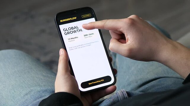 Person reviewing a restaurant franchise opportunity on a smartphone. App shows global growth metrics and a 12-month payback period. Perfect for investment, entrepreneurship, and business scaling