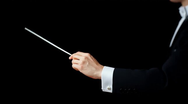 Orchestra conductor's hands holding the baton