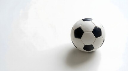 Fototapeta premium Soccer ball on clean white background with soft shadow creating minimal football concept.