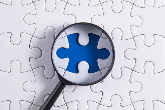 puzzle pieces with a magnifying glass	
