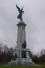 Fototapeta premium Monument With Statue Under Moody Gray Sky