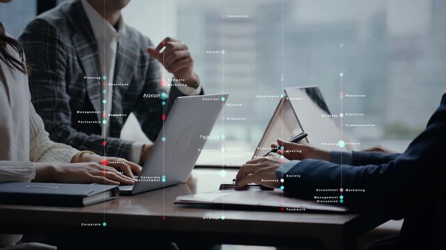 オフィスで会話するビジネスパーソンのグループとデジタルテクノロジーのコンセプトイメージ