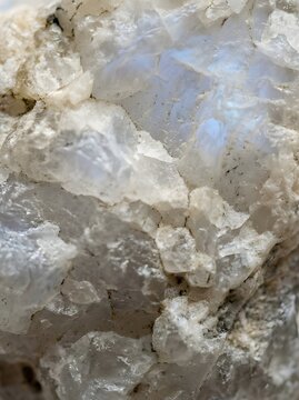 Raw Moonstone Texture Background with Natural Adular Surface High resolution macro texture of raw moonstone (adular) surface with natural mineral structure and subtle internal glow. Organic rough text