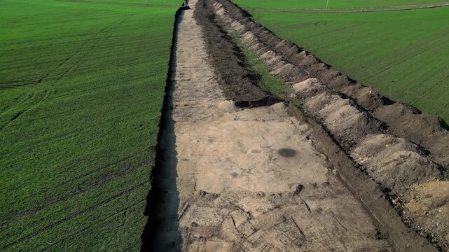  archaeological excavation or construction site where extensive earthworks have been carried out. exposed area with visible which is typical for archaeological surveys. pile of excavated soil, survey 