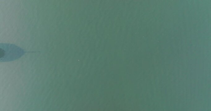 A Large Cargo Shipping Boat As Seen From Above Passing A Peaceful International Water Passage