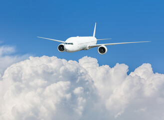 Fototapeta premium White passenger airplane flying in the sky amazing clouds in the background - Travel by air transport